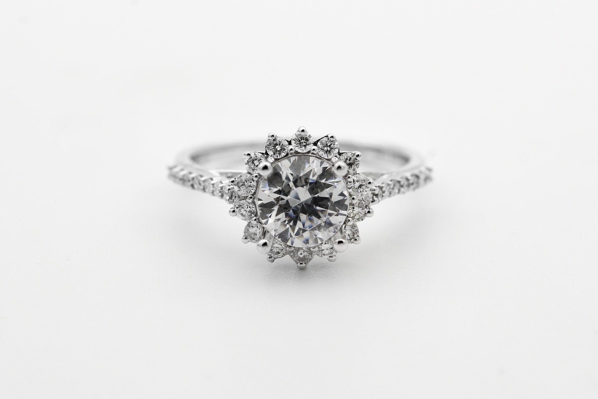 round halo diamond engagement ring on a gray background