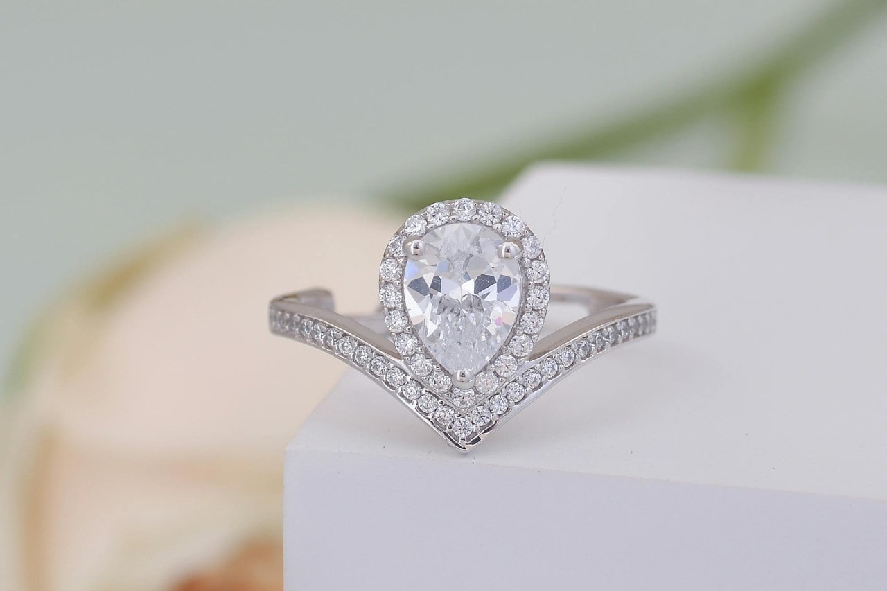 a white gold engagement ring with a pear shape diamond 