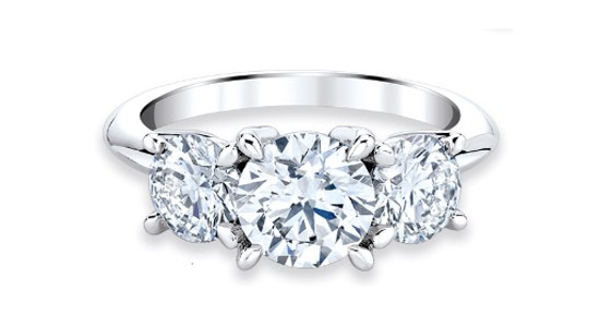 a simple three stone engagement ring with a polished band