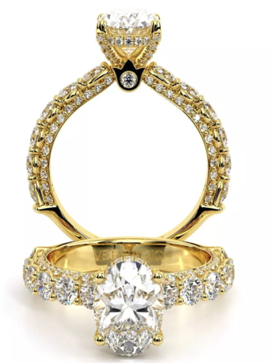 A yellow gold side stone diamond encrusted engagement ring