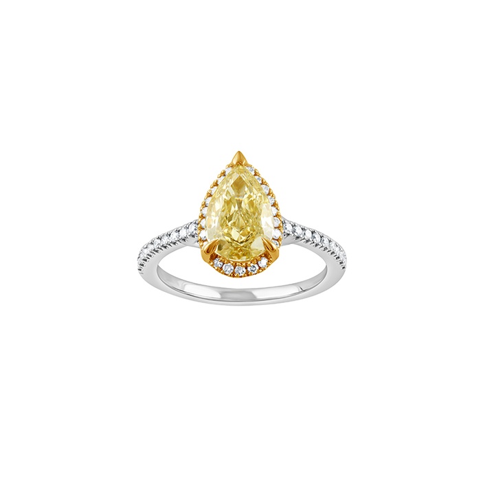 A pear shaped yellow diamond engagement ring with round diamonds placed along the white gold band.
