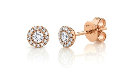 a rose gold pair of stud earrings featuring halo set diamonds