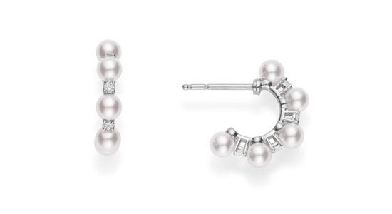 a white gold pair of huggies earrings featuring pearls and diamonds