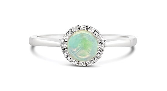 a white gold fashion ring featuring a halo set opal