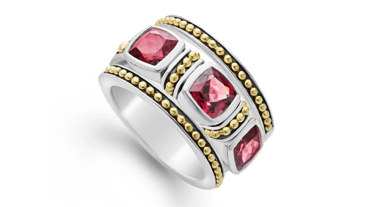 a mixed metal fashion ring featuring red garnet