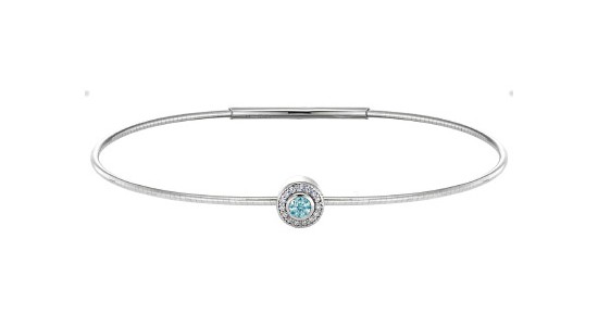 a white gold bracelet featuring a halo set aquamarine