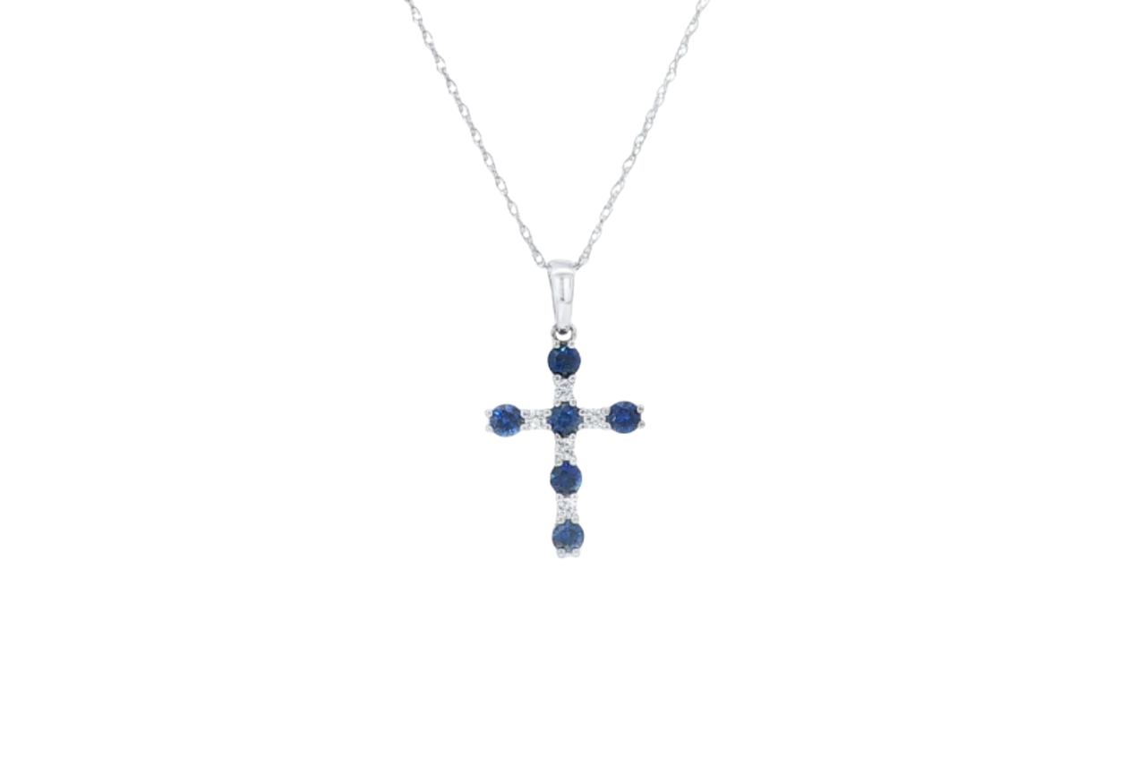 A white gold blue sapphire and diamond cross necklace.