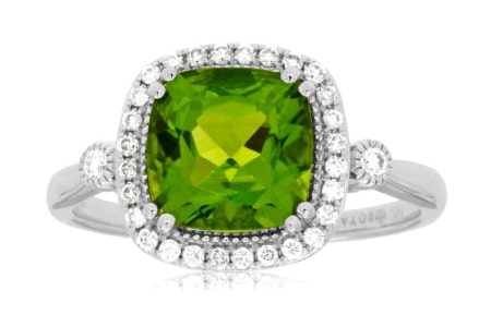 A peridot halo fashion ring set in white gold with diamond accents.