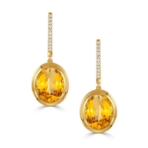 A pair of citrine drop earrings with diamond accents.