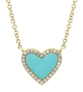 a turquoise heart pendant with diamond accents and a yellow gold chain.