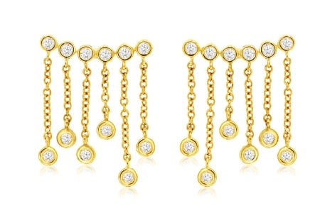 a pair of dangle earrings crafted from yellow gold from our in-house collection.