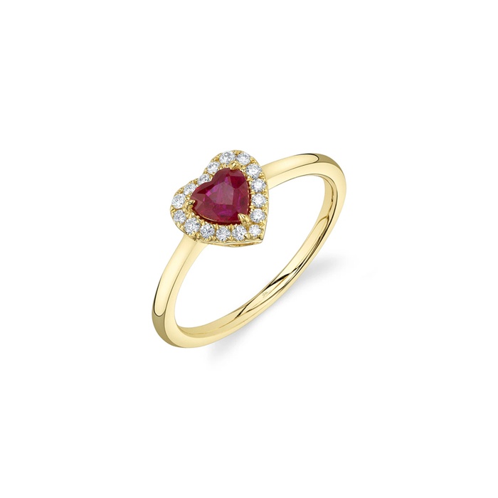 A yellow gold ring with a heart shaped ruby surrounded by a halo of diamonds.
