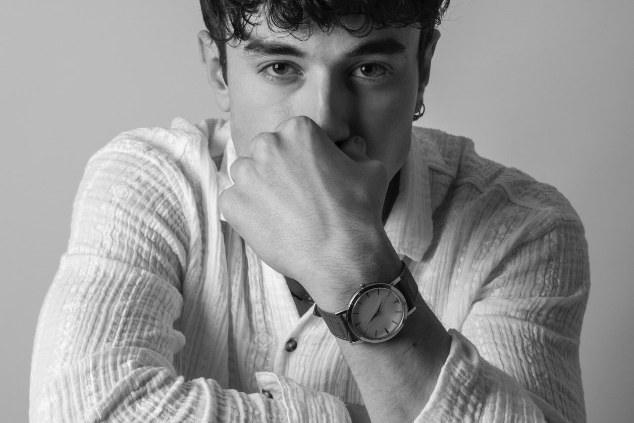 a man wearing a luxury timepiece and fashion jewelry