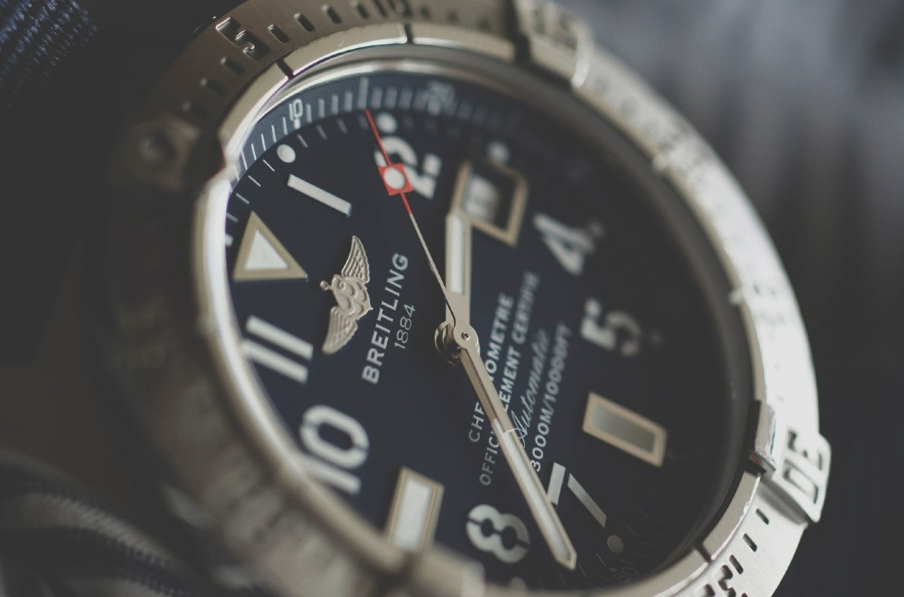 A close-up of a Breitling watch’s deep blue dial with Roman numerals