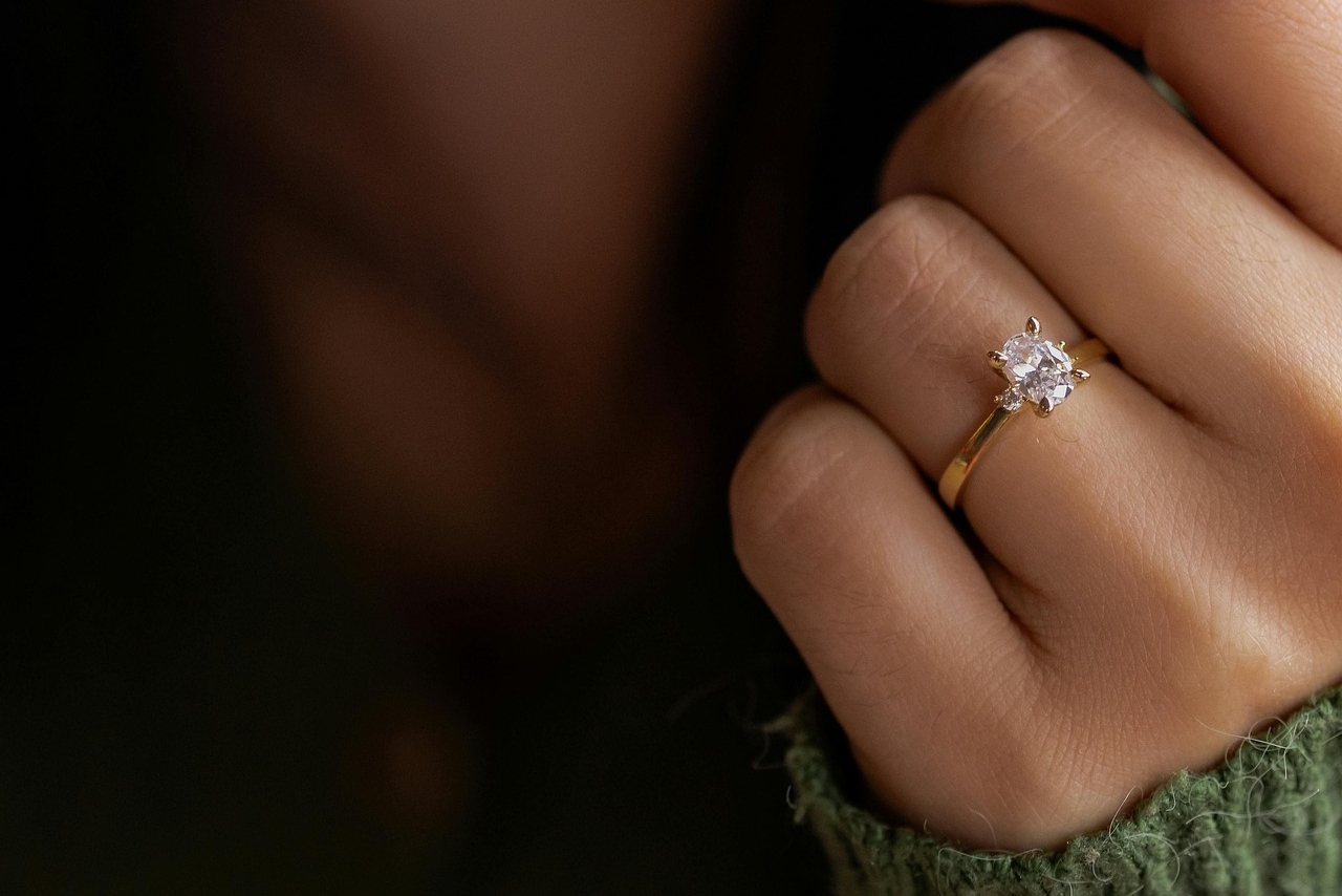 A close-up of a yellow gold diamond engagement ring.